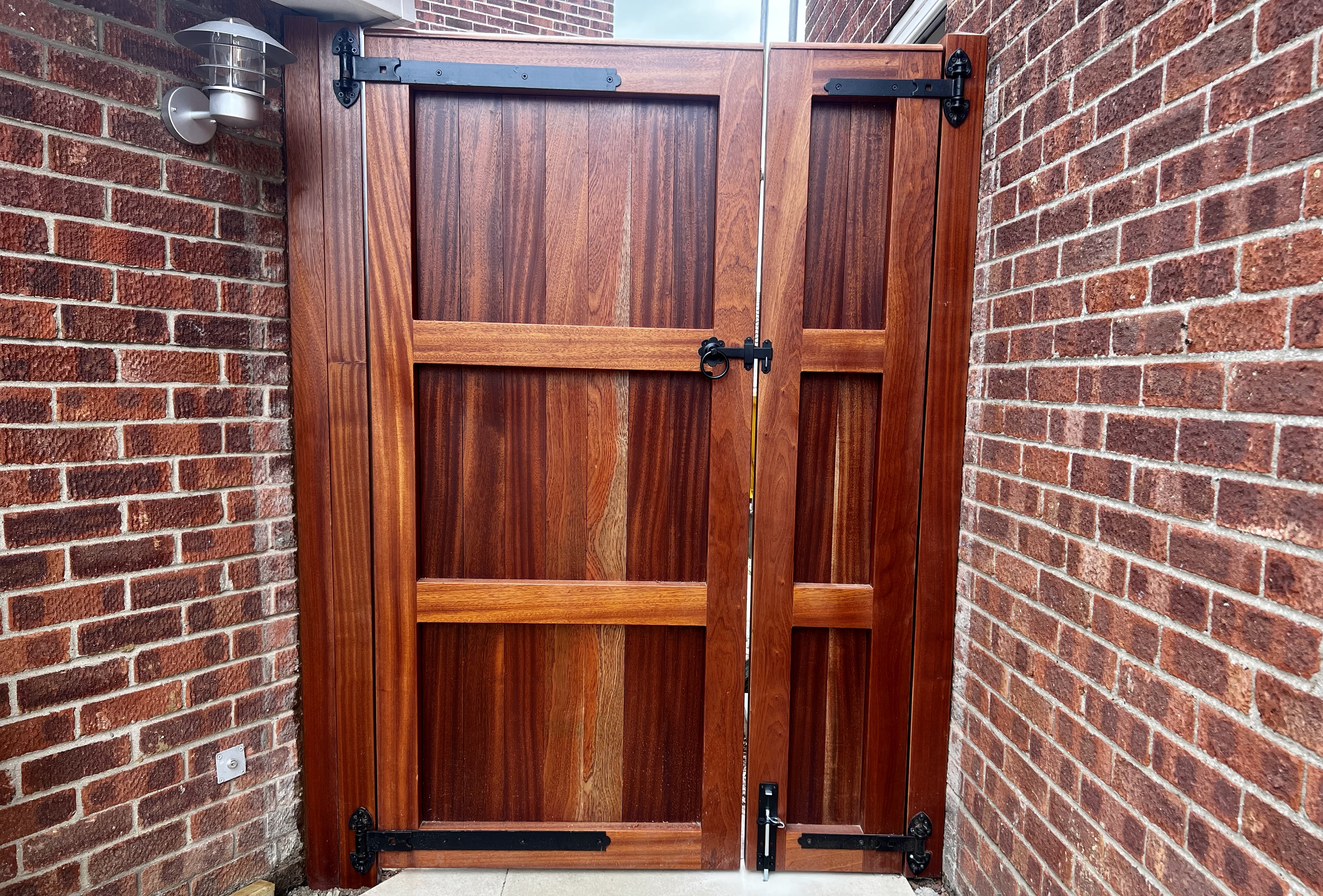 Framed and panelled double gate, wider view showing ironmongery